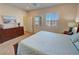 Comfortable bedroom featuring plantation shutters and an inviting king-size bed with blue bedding at 5528 Eleganza Ave, Pahrump, NV 89061