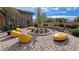 Picturesque courtyard featuring artistic yellow outdoor seating and manicured landscaping at 5528 Eleganza Ave, Pahrump, NV 89061