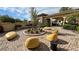 Beautiful courtyard featuring artistic yellow outdoor seating and manicured landscaping at 5528 Eleganza Ave, Pahrump, NV 89061