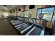 Gym with a row of treadmills overlooking the pool and community at 5528 Eleganza Ave, Pahrump, NV 89061