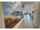 Hallway featuring train mural and tile flooring leading to living spaces with natural light at 5528 Eleganza Ave, Pahrump, NV 89061