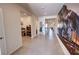 Hallway with tiled flooring, train mural on the wall, and multiple doorways at 5528 Eleganza Ave, Pahrump, NV 89061