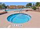 Inviting hot tub with tiled steps, surrounded by a spacious pool deck with additional swimming pools at 5528 Eleganza Ave, Pahrump, NV 89061