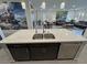 Modern kitchen island with stainless steel appliances and double sink at 5528 Eleganza Ave, Pahrump, NV 89061