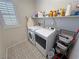 Efficient laundry room with modern appliances and a storage shelf, maximizing space and functionality at 5528 Eleganza Ave, Pahrump, NV 89061