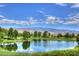 Picturesque golf course view with a serene pond reflecting the blue sky and distant mountains at 5528 Eleganza Ave, Pahrump, NV 89061