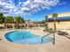 Relaxing pool area with palm trees, lounge chairs, and mountain views in the background at 5528 Eleganza Ave, Pahrump, NV 89061