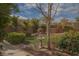 Well-manicured backyard boasting a charming fountain, verdant lawn, and a relaxing hot tub area at 5989 Sierra Medina Ave, Las Vegas, NV 89139