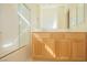 Sunlit bathroom featuring double sinks, wood cabinetry, shower over tub and tile floors at 5989 Sierra Medina Ave, Las Vegas, NV 89139