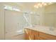 Bathroom featuring a tub, a shower with glass doors, and a double vanity sink at 5989 Sierra Medina Ave, Las Vegas, NV 89139