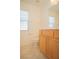 Bathroom with single sink vanity, wooden cabinets, toilet and blinds on the window at 5989 Sierra Medina Ave, Las Vegas, NV 89139