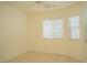 A bright bedroom featuring tiled floors with natural light and a ceiling fan at 5989 Sierra Medina Ave, Las Vegas, NV 89139