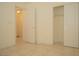 Neutral bedroom featuring tiled floors and a closet and doorway at 5989 Sierra Medina Ave, Las Vegas, NV 89139