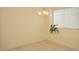 Bright dining area with tile floors, a chandelier and a large window with a plant in the window well at 5989 Sierra Medina Ave, Las Vegas, NV 89139