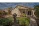 Cozy single-story home featuring a stucco exterior, desert landscaping, and a welcoming covered entrance at 5989 Sierra Medina Ave, Las Vegas, NV 89139