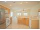 Kitchen area with a peninsula countertop, stainless steel refrigerator and tile floors at 5989 Sierra Medina Ave, Las Vegas, NV 89139