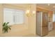 Bright kitchen area with tile floors, a chandelier, stainless steel refrigerator and a large window with a plant in the window well at 5989 Sierra Medina Ave, Las Vegas, NV 89139