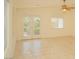 Living room with tile flooring, ceiling fan, double doors, and large window at 5989 Sierra Medina Ave, Las Vegas, NV 89139