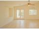 Living room with tile flooring, ceiling fan, French doors and a window at 5989 Sierra Medina Ave, Las Vegas, NV 89139