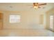 Large, bright living room with a window, ceiling fan and tile floors at 5989 Sierra Medina Ave, Las Vegas, NV 89139