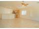 View of the living room with tile flooring, ceiling fan, and kitchen in the background at 5989 Sierra Medina Ave, Las Vegas, NV 89139