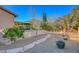 Manicured backyard with covered patio, gravel area, and walkways at 6156 Twilight Cove Cir, Las Vegas, NV 89131