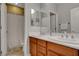 Bathroom featuring double sinks with modern fixtures and a separate shower at 6156 Twilight Cove Cir, Las Vegas, NV 89131