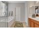 The bathroom features a soaking tub with glass shower, a vanity, and neutral color scheme at 6156 Twilight Cove Cir, Las Vegas, NV 89131