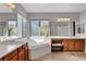 Bright bathroom featuring double vanity, soaking tub under the window, and glass enclosed shower at 6156 Twilight Cove Cir, Las Vegas, NV 89131