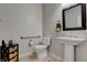 Powder room featuring a pedestal sink, stylish mirror, and neutral decor at 6156 Twilight Cove Cir, Las Vegas, NV 89131