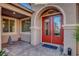 Inviting front door and entry area, featuring double doors, brick paving and a sitting Buddha at 6156 Twilight Cove Cir, Las Vegas, NV 89131