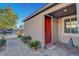 Inviting entryway with decorative plants and red door featuring paver pathway at 6156 Twilight Cove Cir, Las Vegas, NV 89131