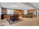 Bright kitchen with ample cabinets, stainless appliances, island seating, and adjacent dining area at 6156 Twilight Cove Cir, Las Vegas, NV 89131