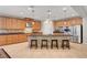 Spacious kitchen island with seating featuring stainless steel appliances and tile backsplash at 6156 Twilight Cove Cir, Las Vegas, NV 89131