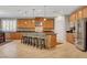 A spacious kitchen features an island with seating, stainless steel appliances, and ample cabinetry at 6156 Twilight Cove Cir, Las Vegas, NV 89131