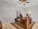 Comfortable home office with ceiling fan, classic wooden desk, and tile floor at 6156 Twilight Cove Cir, Las Vegas, NV 89131