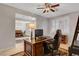 Office leading to dining, featuring a large wooden desk and chair, bathed in natural light at 6156 Twilight Cove Cir, Las Vegas, NV 89131