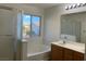 Bathroom featuring a glass shower, a soaking tub, and a wood vanity with dual sinks at 6425 W Haleh Ave, Las Vegas, NV 89141