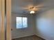 This cozy bedroom features neutral carpet, a ceiling fan, and a window with natural light at 6425 W Haleh Ave, Las Vegas, NV 89141