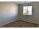 Bright bedroom showcasing neutral carpet, window with blinds, and clean, painted walls at 6425 W Haleh Ave, Las Vegas, NV 89141