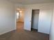 This cozy bedroom features neutral carpet and view of large closet space at 6425 W Haleh Ave, Las Vegas, NV 89141