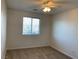 This cozy bedroom features neutral carpet, a ceiling fan, and a window with natural light at 6425 W Haleh Ave, Las Vegas, NV 89141