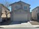 Traditional two-story home featuring a two-car garage and neutral-colored facade at 6425 W Haleh Ave, Las Vegas, NV 89141