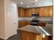 Kitchen featuring stainless steel appliances, an island, and wood cabinets at 6425 W Haleh Ave, Las Vegas, NV 89141