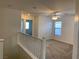 Upstairs living area with plush carpeting, bright windows, and modern ceiling fan at 6425 W Haleh Ave, Las Vegas, NV 89141