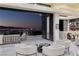 Spacious balcony with comfortable seating and stunning city views at twilight at 667 Solitude Rock Ct, Henderson, NV 89012