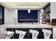 Wet bar area with marble countertops and city views through a bright window at 667 Solitude Rock Ct, Henderson, NV 89012