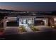 Striking modern home exterior at twilight with a three-car garage and manicured front yard at 667 Solitude Rock Ct, Henderson, NV 89012