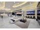 Open concept living room with marble floors and an expansive sliding glass door leading to outdoor views at 667 Solitude Rock Ct, Henderson, NV 89012