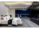 Modern main bedroom featuring a king bed, city views, and a black marble fireplace and accent wall at 667 Solitude Rock Ct, Henderson, NV 89012